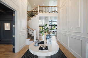 Foyer featuring light hardwood / wood-style floors and a high ceiling