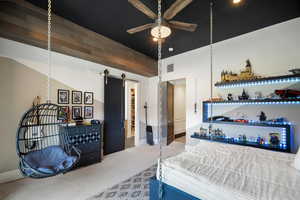 Carpeted bedroom featuring a barn door