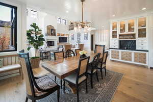 Dining room featuring wood ceiling, a notable chandelier, light wood-type flooring, and built in features