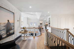 Hall featuring light hardwood / wood-style flooring and a tray ceiling