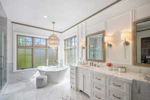 Bathroom featuring tile floors, large vanity, ornamental molding, shower with separate bathtub, and a notable chandelier