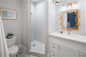 Bathroom featuring tile floors, oversized vanity and a tile shower