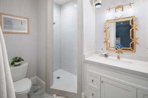 Bathroom featuring tile floors, oversized vanity and a tile shower