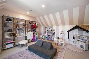 Playroom with lofted ceiling and carpet flooring