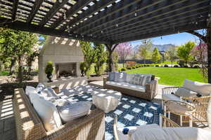 View of terrace with an outdoor living space with a fireplace and a pergola