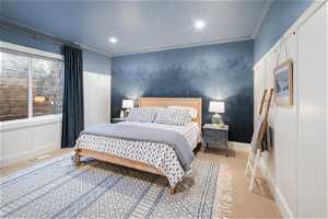 Carpeted bedroom with ornamental molding and mural