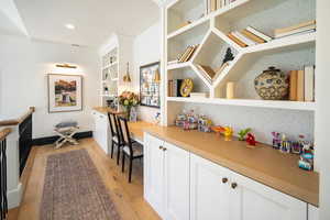 Study area with light hardwood / wood-style flooring