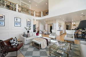 Living room with hardwood / wood-style flooring and a high ceiling