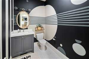 Bathroom with vanity with extensive cabinet space and tile flooring