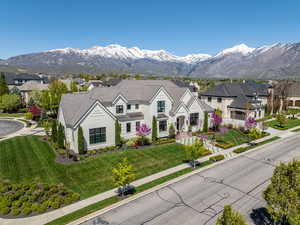 View of front of house with a mountain view and a front yard