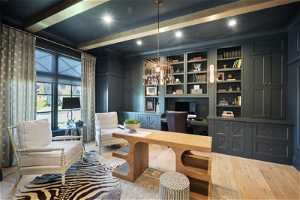 Home office featuring hardwood / wood-style flooring, built in features, beamed ceiling, and a chandelier
