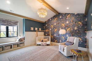 Sitting room featuring lofted ceiling with beams, carpet, and an inviting chandelier