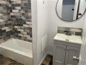 Bathroom featuring vanity with extensive cabinet space and tile flooring