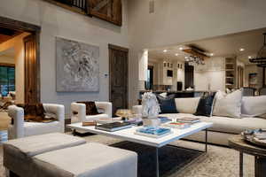 Living room featuring a chandelier and a high ceiling