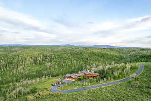View of subject property featuring a heavily wooded area and a mountainous background