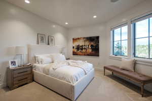 Bedroom with light colored carpet and recessed lighting