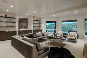 Living room with light carpet, recessed lighting, and plenty of natural light