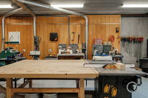 Garage featuring a workshop area and a wood stove