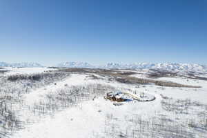 Snowy aerial view featuring a mountain view