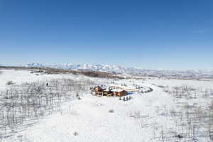 Snowy aerial view featuring a mountain view