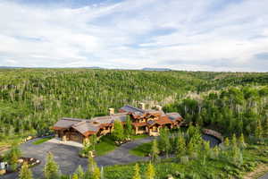 View from above of property featuring a heavily wooded area