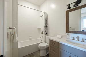 Bathroom with shower / bathtub combination with curtain, vanity, and wood finished floors