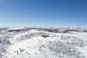 Snowy aerial view featuring a mountain view