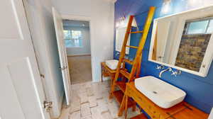 1st basement bedroom featuring two sinks