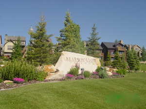 Community / neighborhood sign featuring a lawn