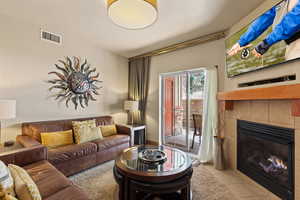 Tiled living room featuring a fireplace