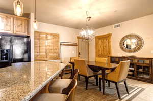 Tiled dining area featuring a chandelier