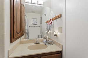 Bathroom featuring vanity, toilet, and a textured ceiling