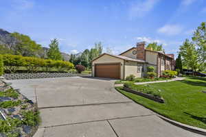 View of front of home featuring a garage and a front yard