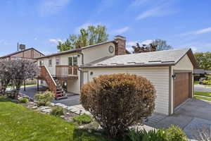 Exterior space featuring a wooden deck and a garage