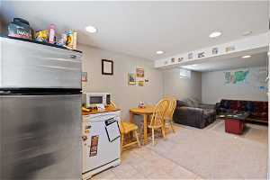 Kitchen featuring stainless steel refrigerator, light tile floors, and fridge