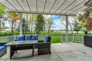 View of patio with an outdoor living space and a pergola