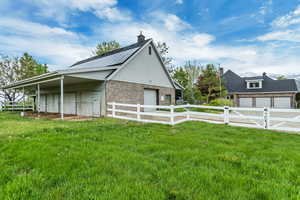 View of home's exterior featuring a garage and a lawn