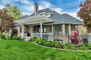 View of front of property featuring a front yard and a pergola