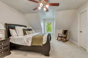 Carpeted bedroom with ceiling fan