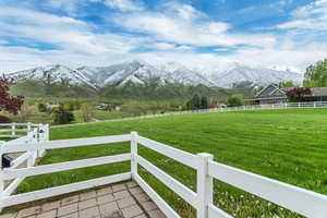 View of yard with a rural view and a mountain view