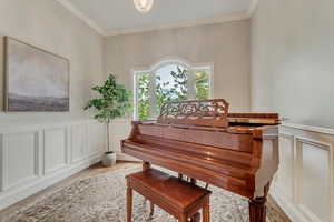 Misc room featuring ornamental molding and light wood-type flooring