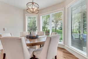 Dining area featuring light hardwood / wood-style flooring and an inviting chandelier