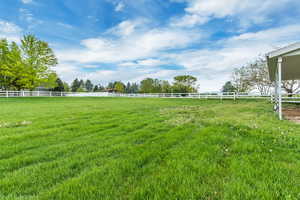 View of yard with a rural view