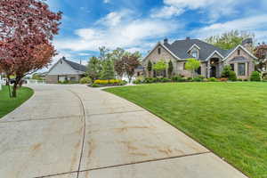 View of front of house featuring a garage and a front lawn