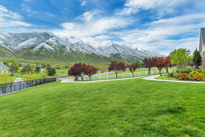 View of nearby features with a mountain view and a lawn