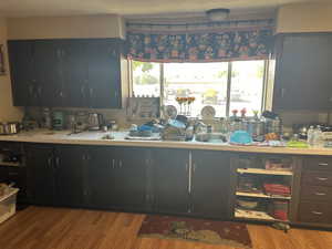 Kitchen with a textured ceiling and light hardwood / wood-style floors