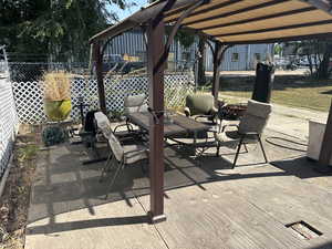 View of patio / terrace featuring a wooden deck and a fire pit