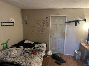 Other view of Bedroom#2 upstairs featuring hardwood / wood-style floors and a textured ceiling