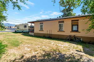 Lateral North View of the old home's exterior featuring a lawn