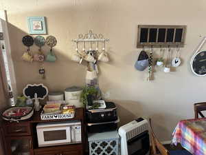 Kitchen with dark brown cabinetry and heating unit